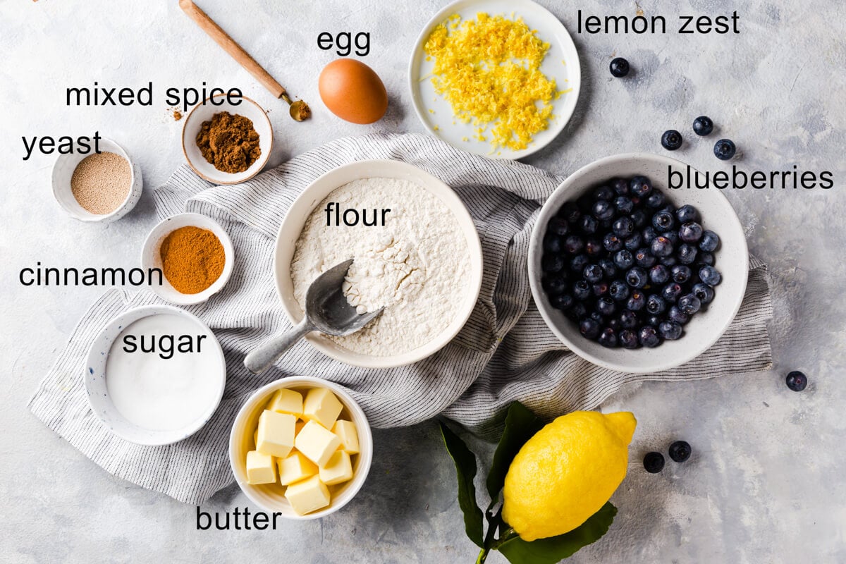top view of the ingredients for blueberry hot cross buns with text labels