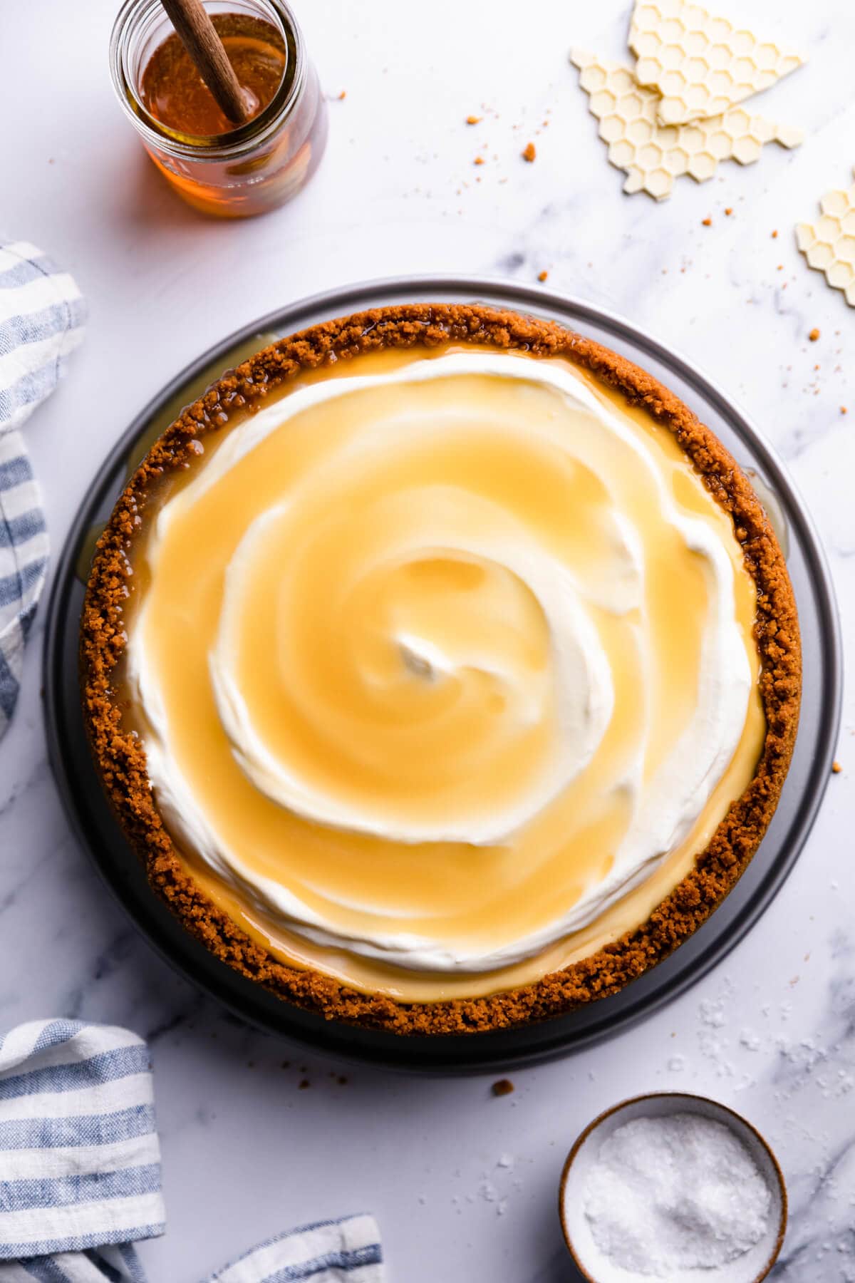 top view of the cheesecake topped with cream and salted honey