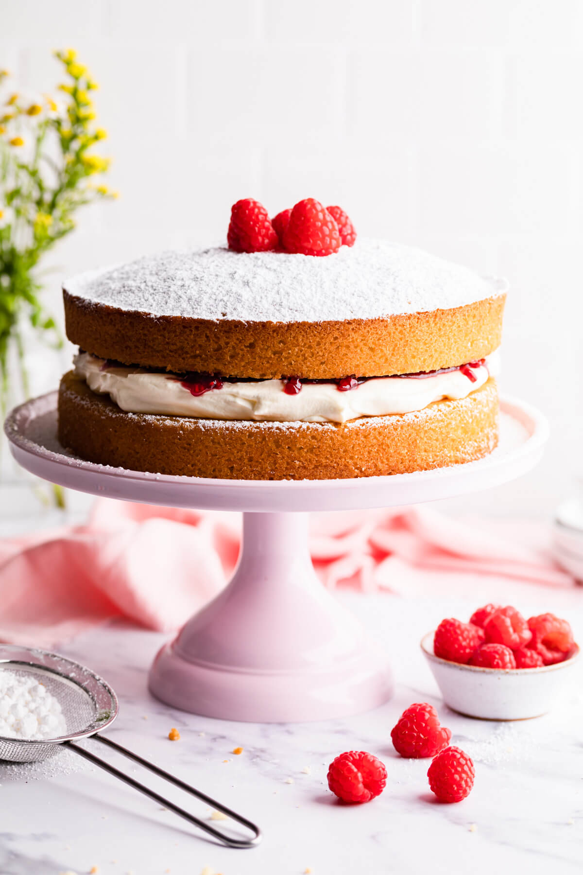 Victoria sandwich cake on a pink cake stand