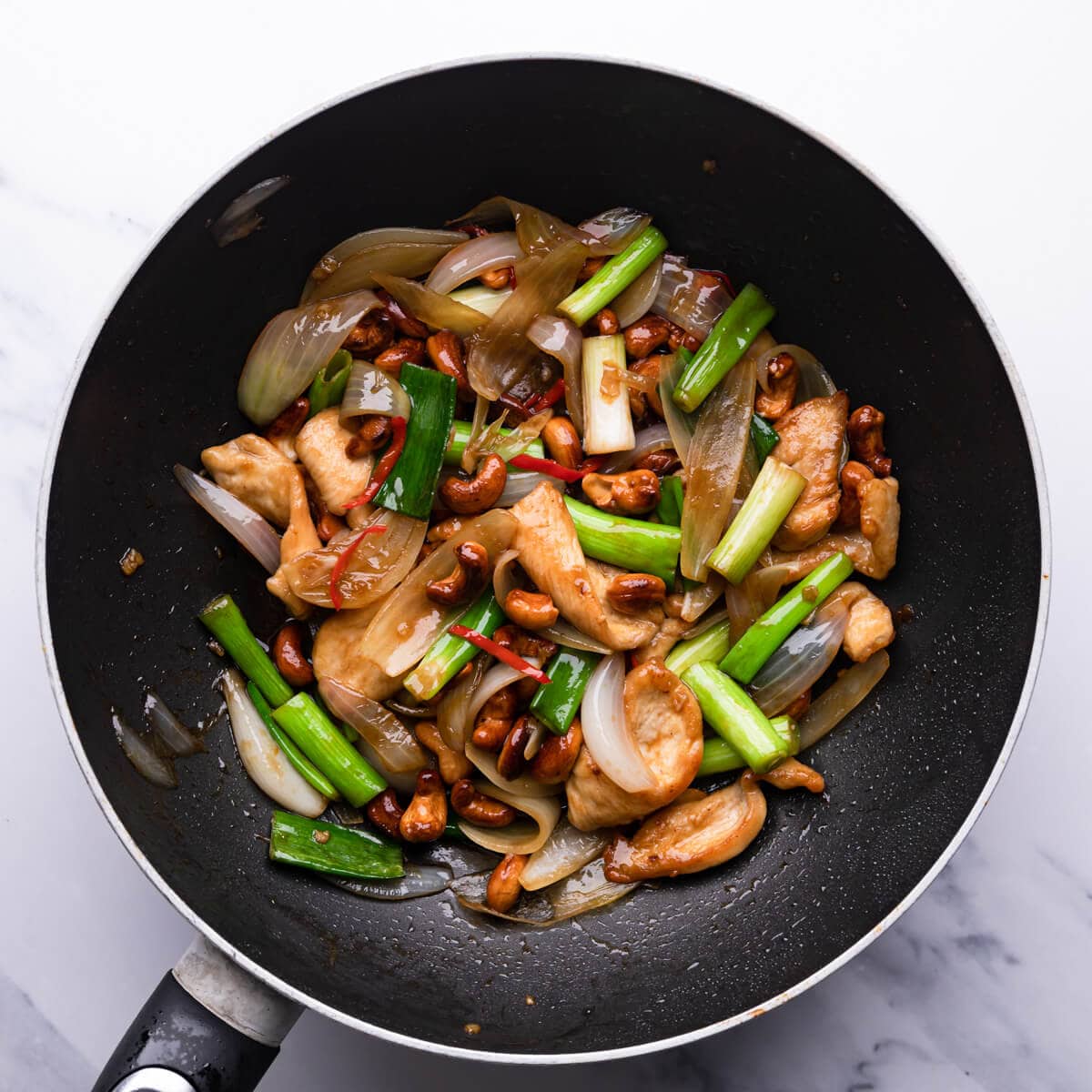 top down view of the cashew chicken in a wok pan