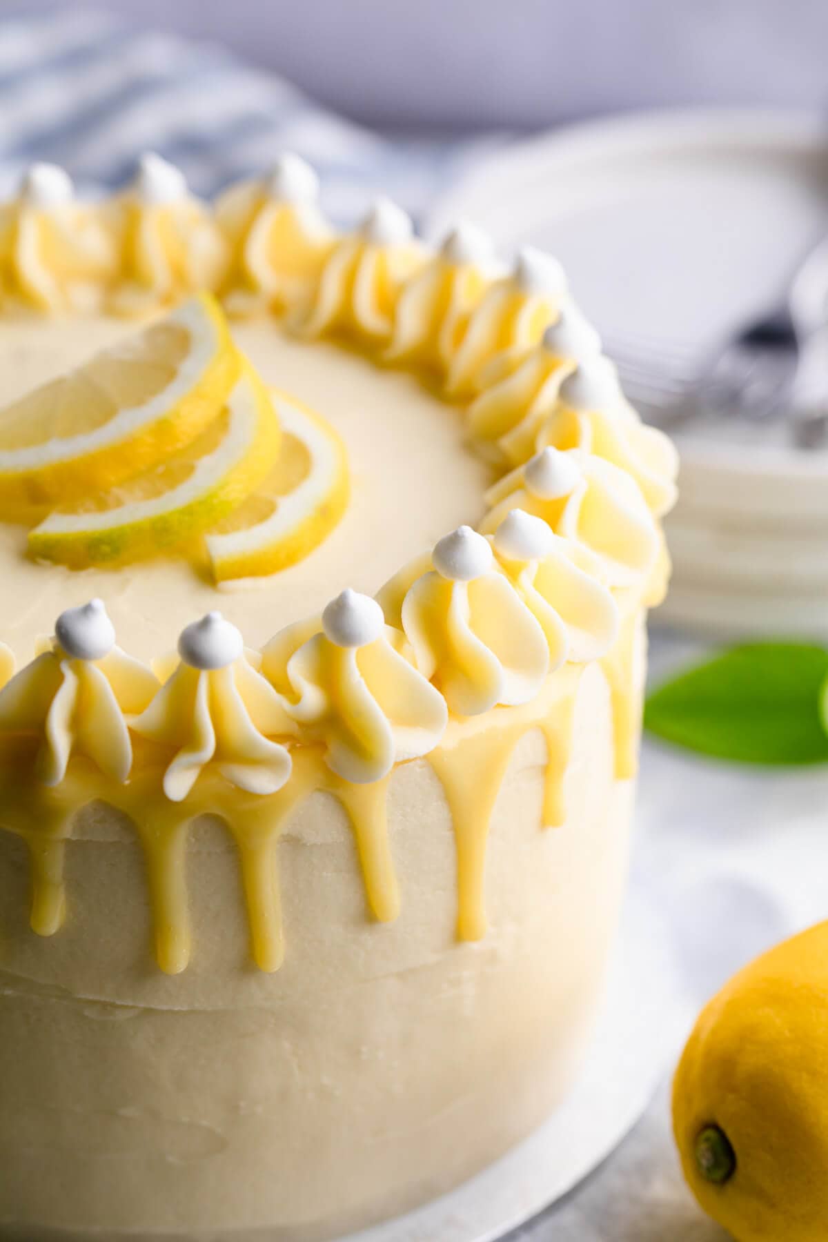 45 degree super close up at lemon and elderflower cake with ganache drip
