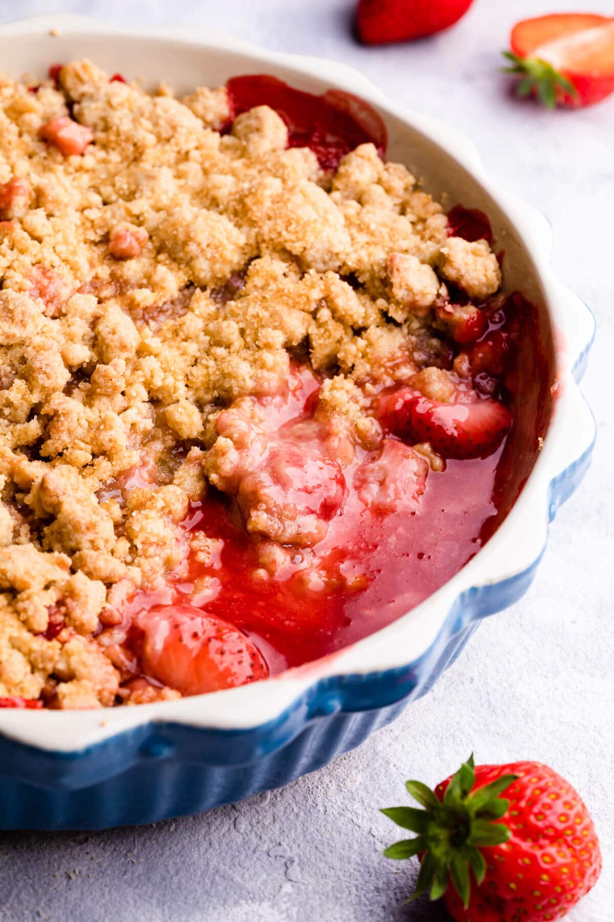 side super close up at a strawberry crumble in a baking dish
