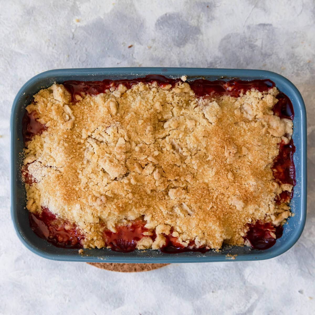 overhead view of a strawberry crumble made with butter rubbed into the flour