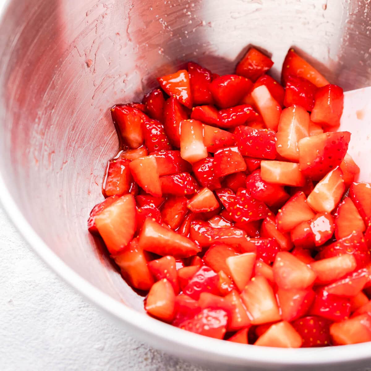 side super close up at chopped strawberries in a bowl
