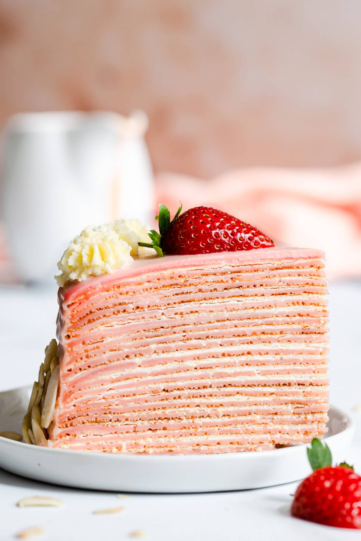 side super close up at a slice of strawberry crepe cake