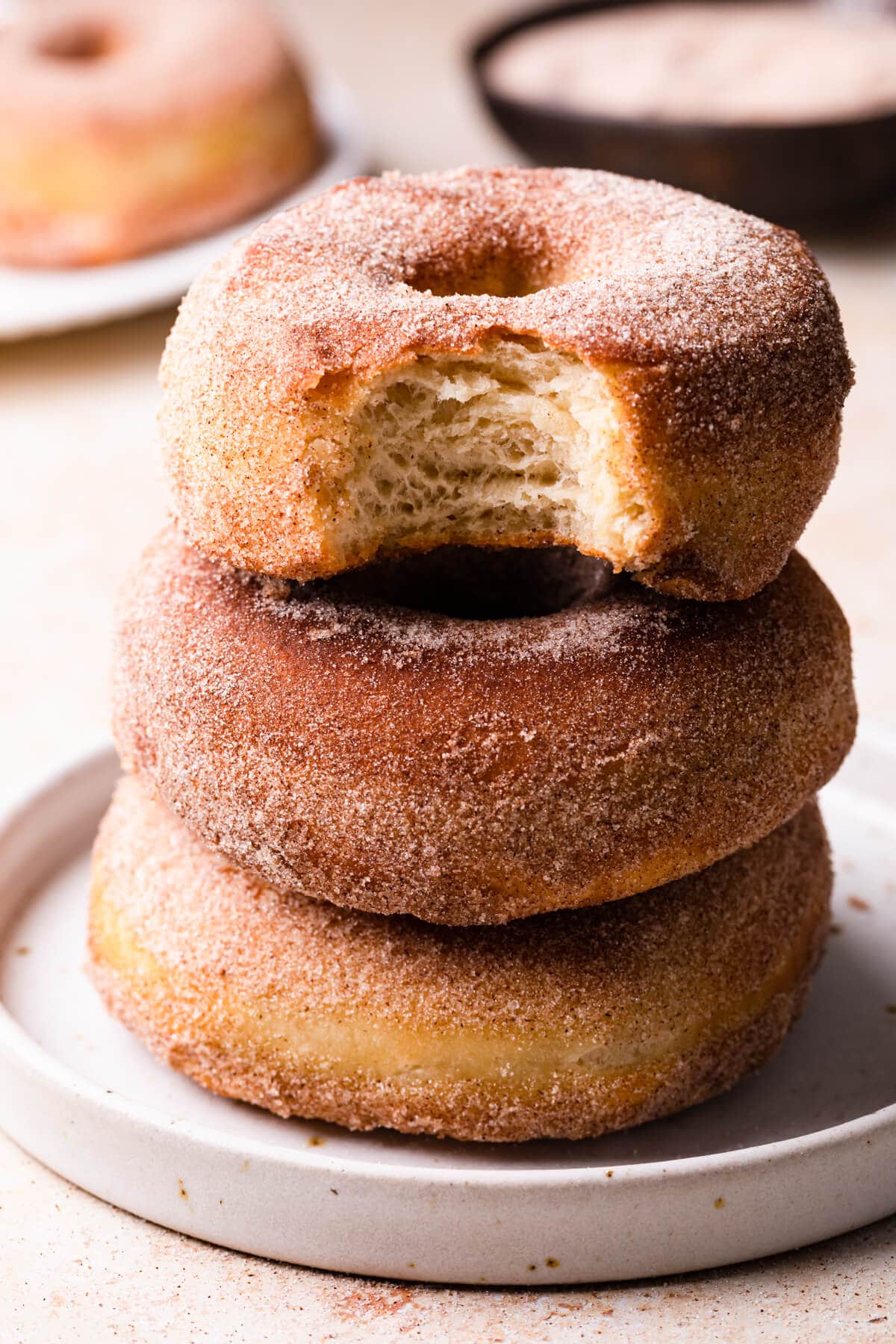 a stack of three air fryer doughnuts on a small plate.