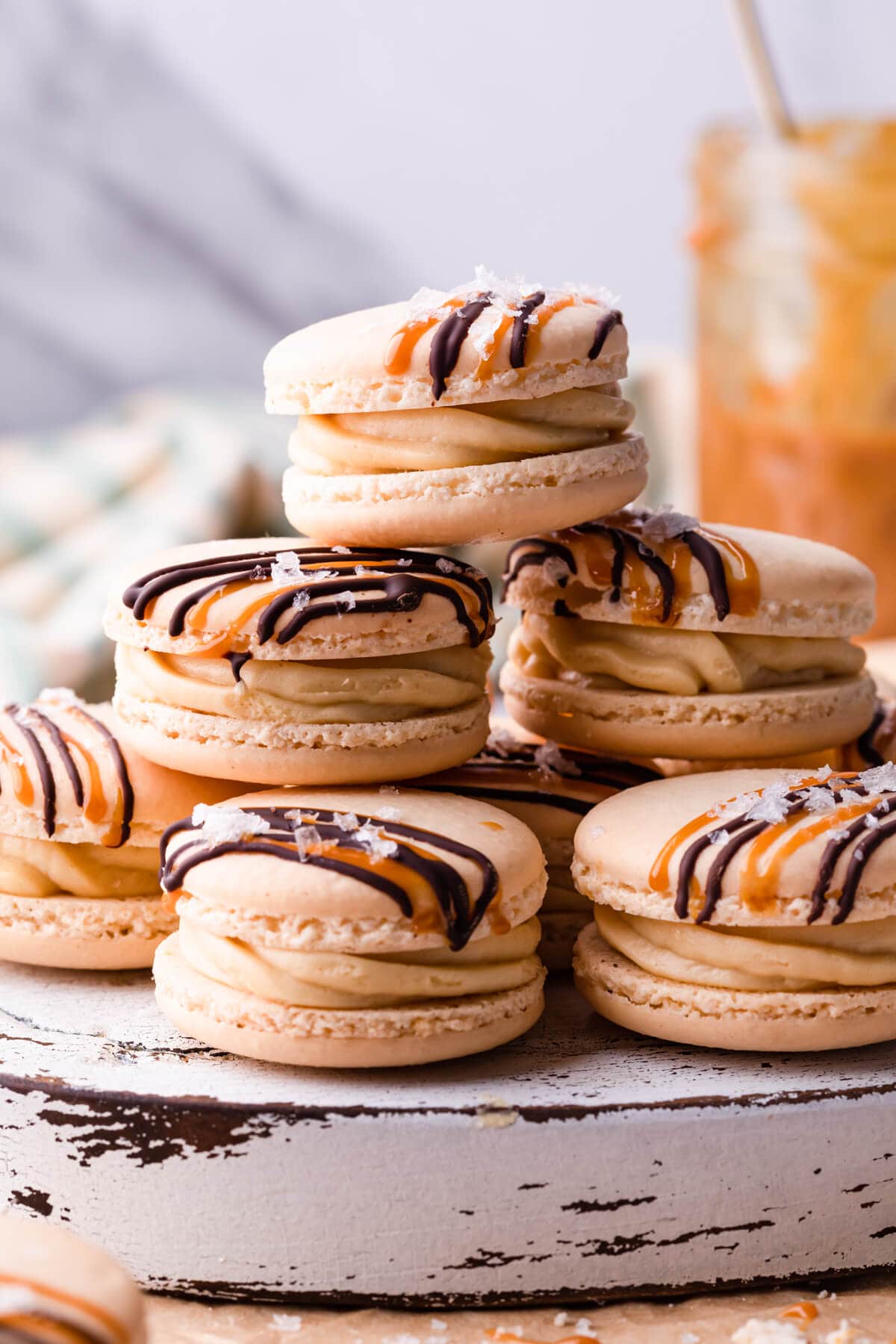 stack of macarons with salted caramel buttercream and drizzle of chocolate and caramel.
