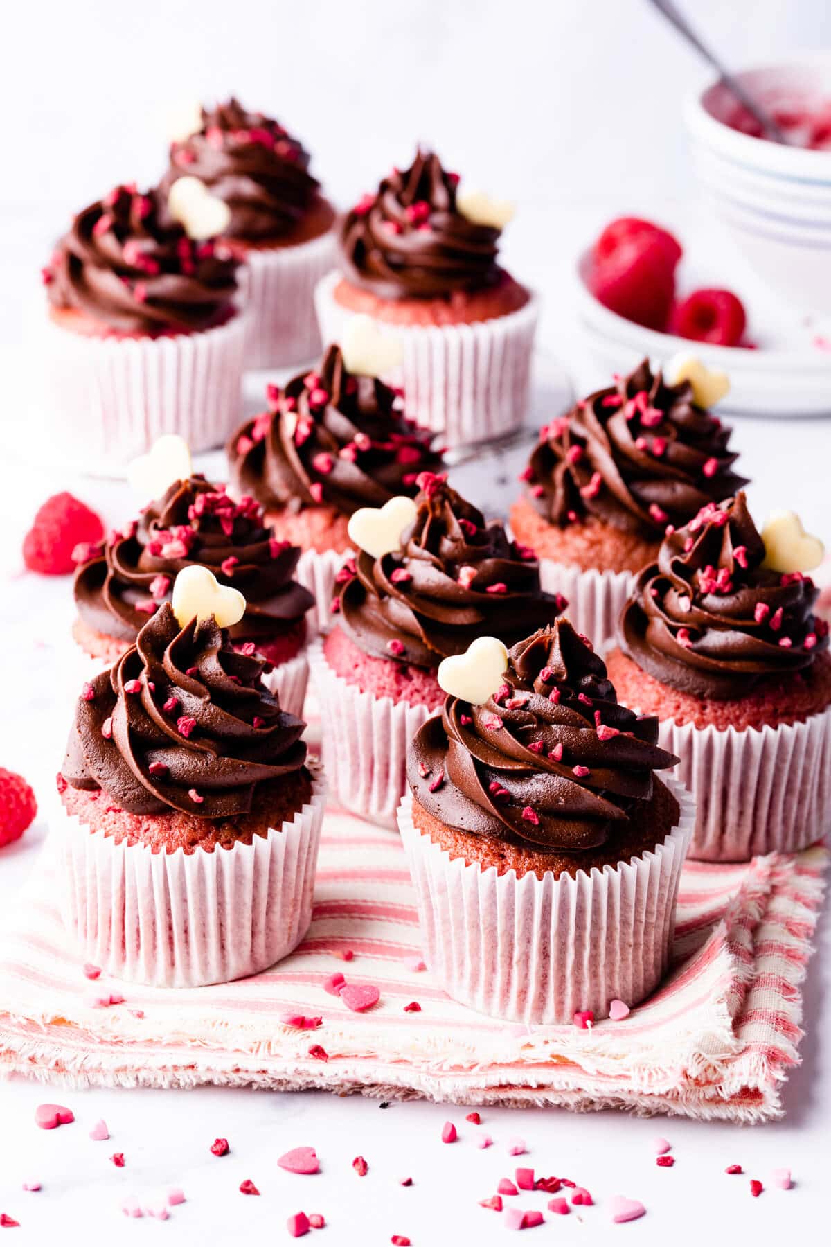 chocolate raspberry cupcakes topped with white chocolate hearts.