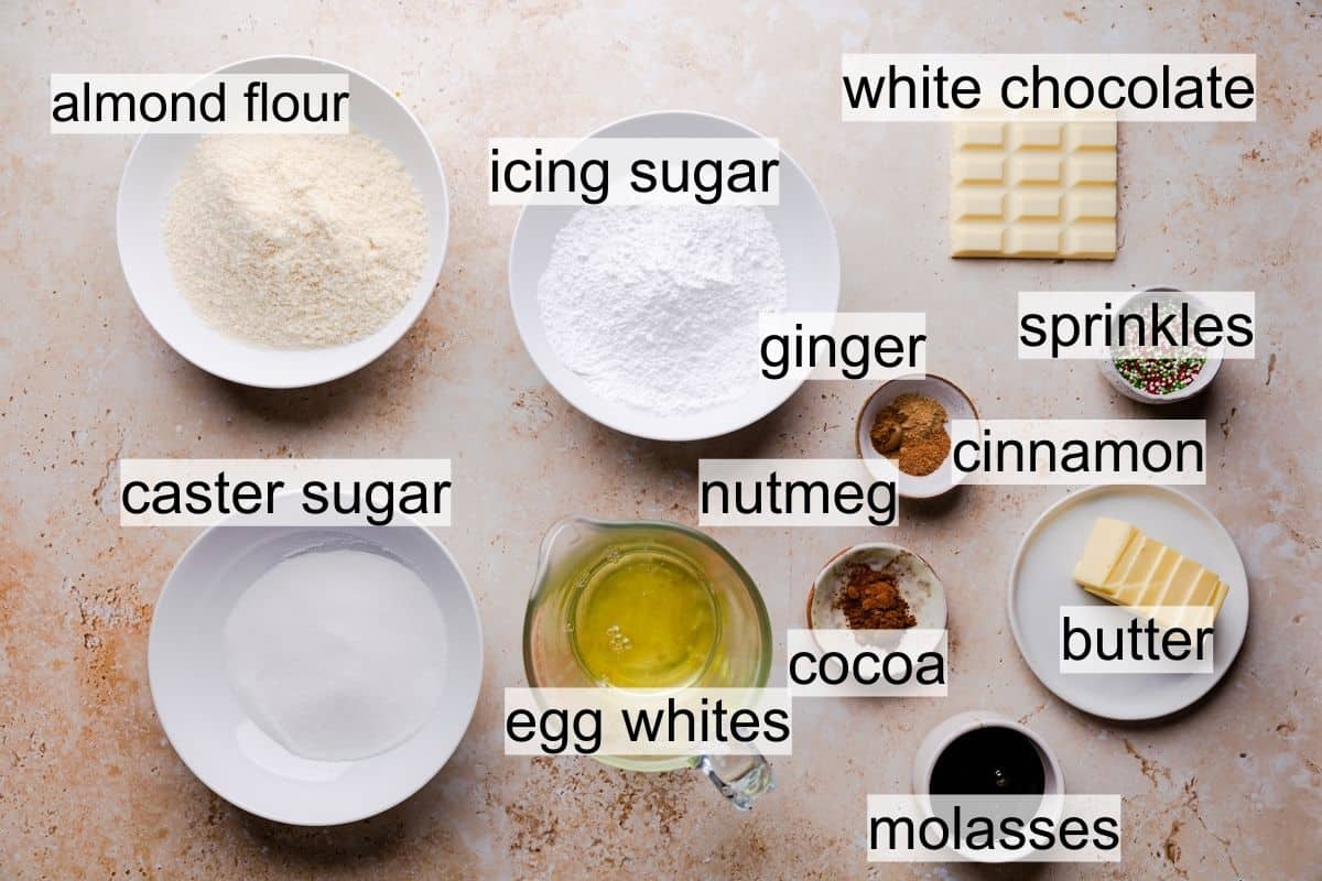 ingredients for gingerbread macarons in bowls and ramekins with text overlay.
