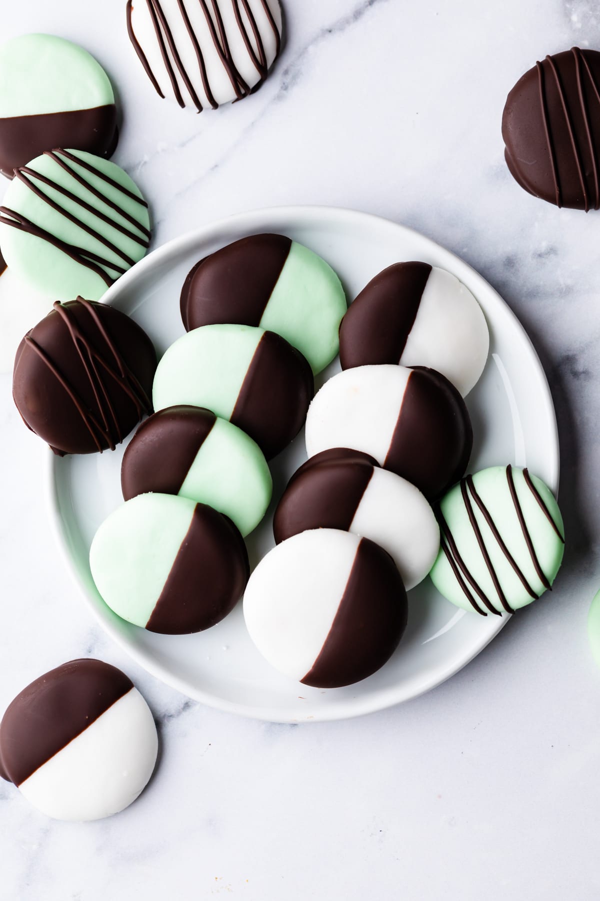 mint creams sweets with chocolate dip on a small plate.