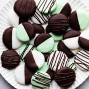 large scalloped plate with chocolate dipped peppermint creams on it.