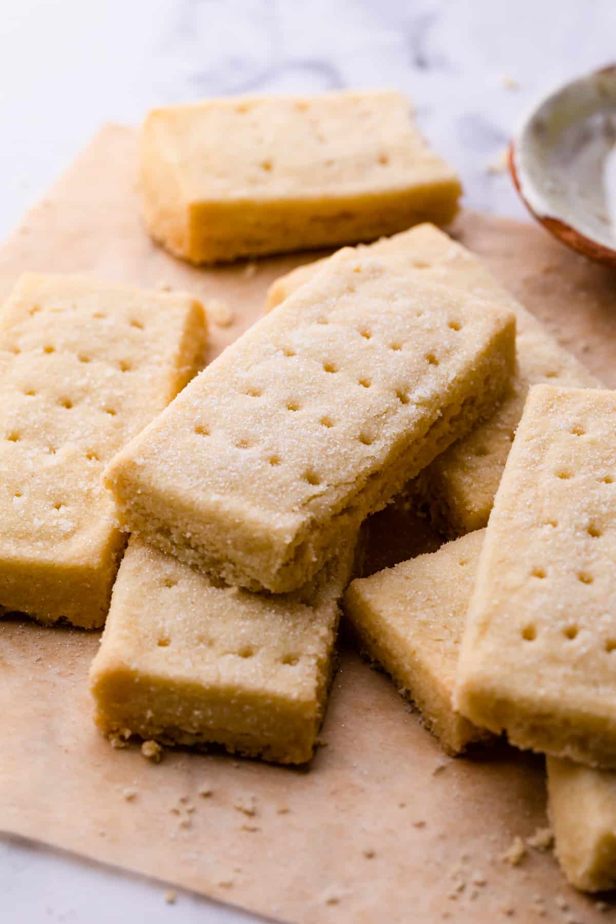 slices of shortbread fingers on a brown baking paper.